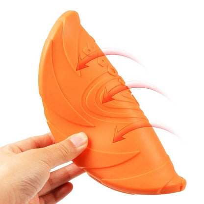 Close-up of orange Rubber Pupp Frisbee showcasing spiral design and flexible edges.