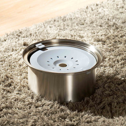 Stainless steel Zero Splash Ultra pet water bowl with floating plate on a rug.