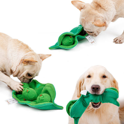 Dog playing with PuppHub Pea Pod Toy featuring soft green flannel and squeaky peas.