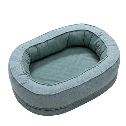 Washable teal oval dog bed with plush interior for stylish pet relaxation