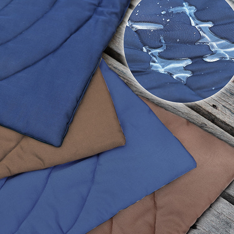 Close-up of foldable waterproof dog mats in navy blue and brown, showcasing texture.