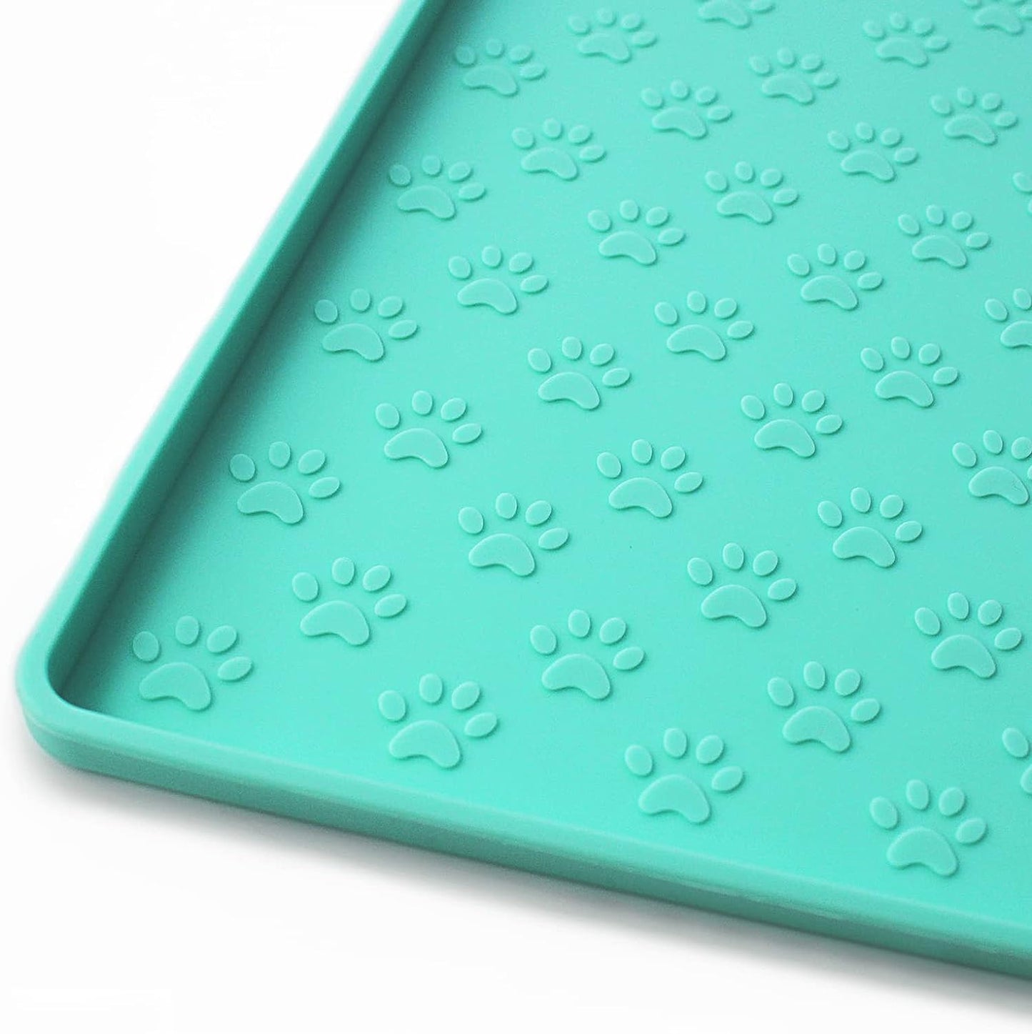 Teal silicone feeding mat with paw print texture, ideal for containing pet food messes.