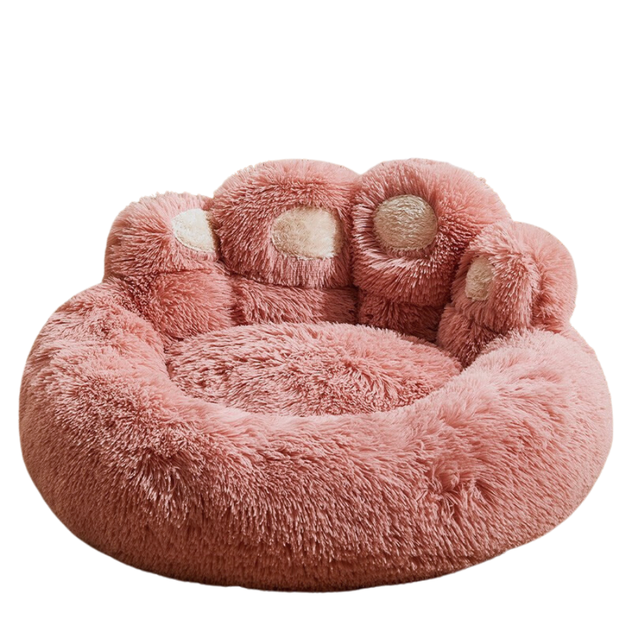 Soft pink PlushPupp bed designed like a paw, offering cozy comfort for pets.