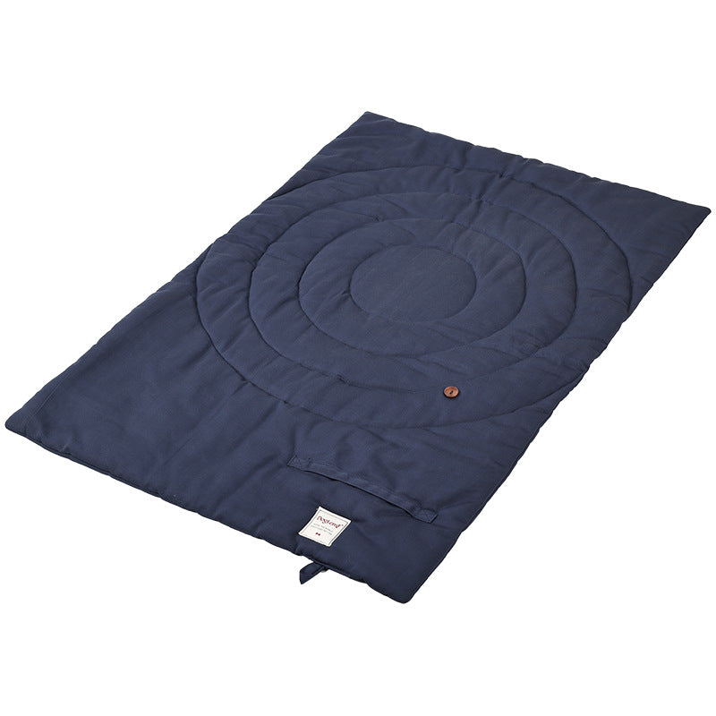 Navy blue foldable mat for dogs with a circular design for comfortable sleeping.